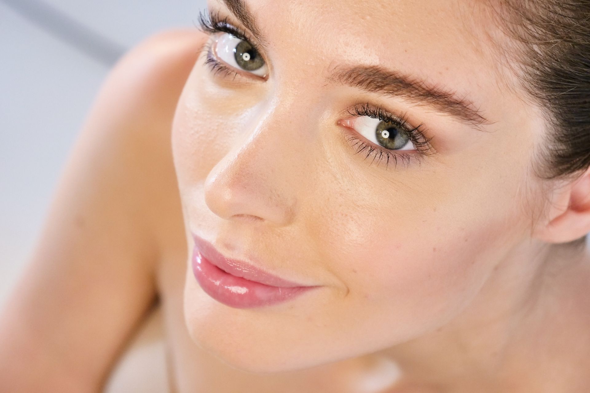 a close up of a woman 's face with a smile on her face .