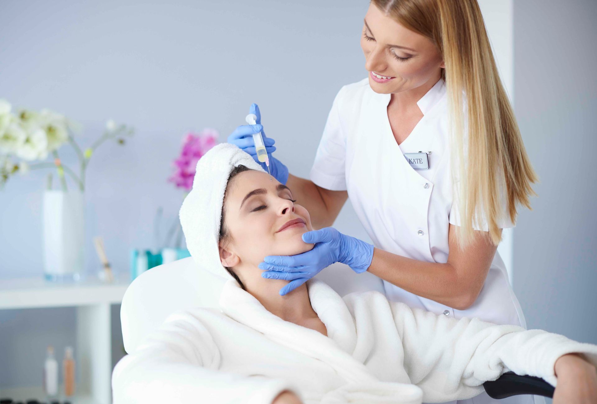 a woman is getting an injection in her face at a beauty salon .