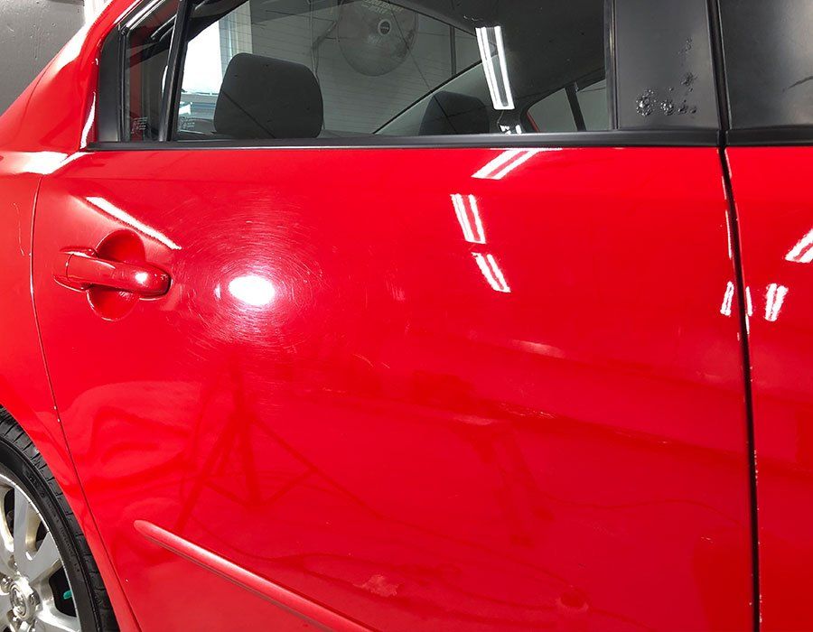 red car that needs paint correction