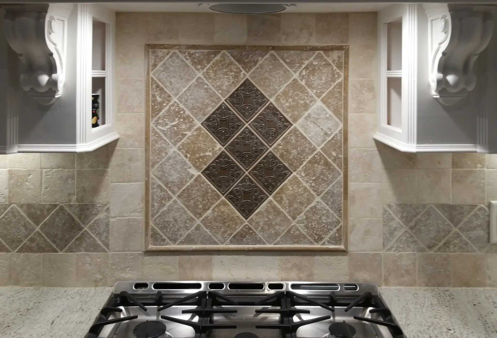 A Kitchen With A Stove Top Oven And A Tiled Wall - Raymond, MS - Parker Roofing & Remodeling