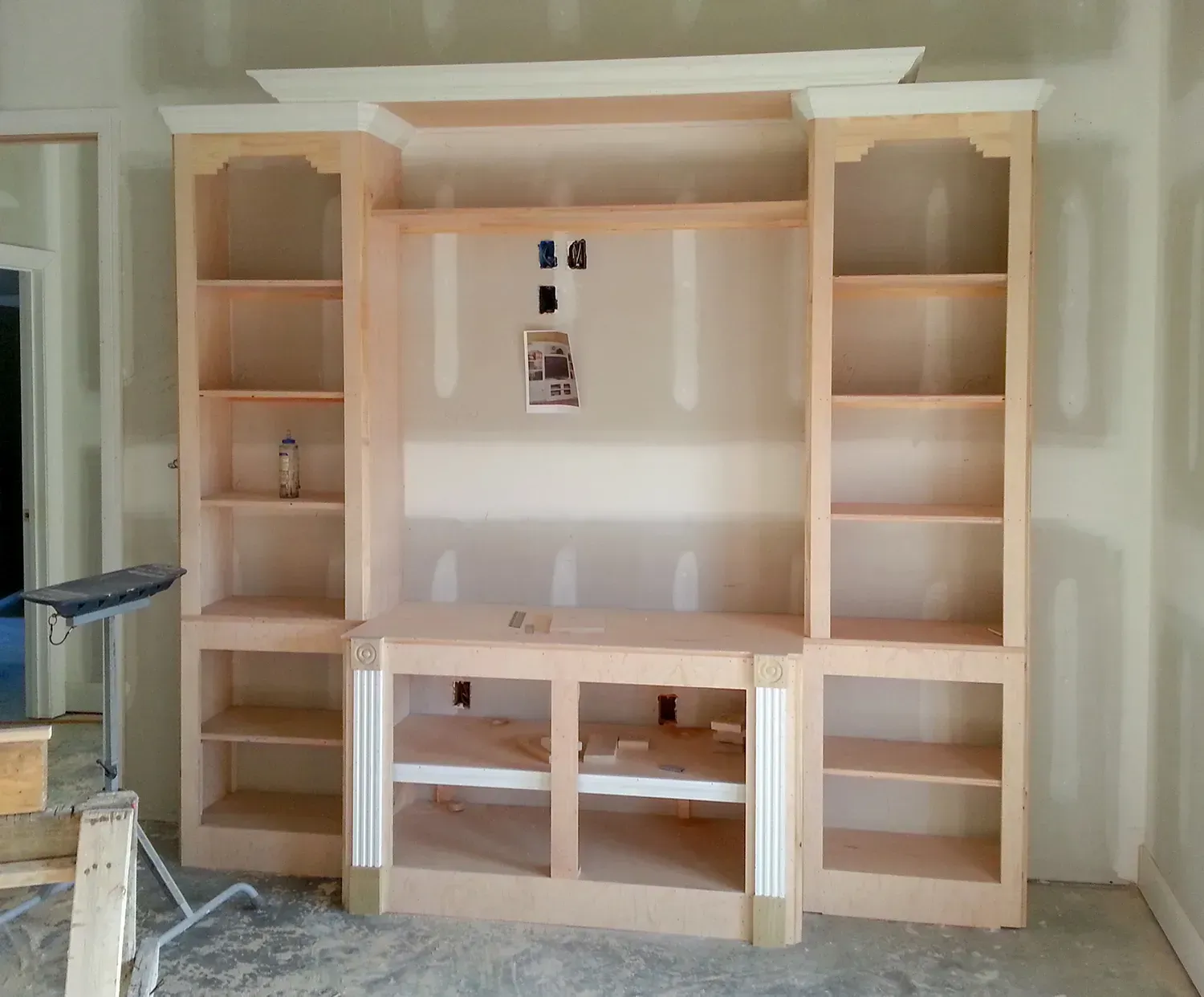 A Wooden Entertainment Center Is Being Built In A Room - Raymond, MS - Parker Roofing & Remodeling