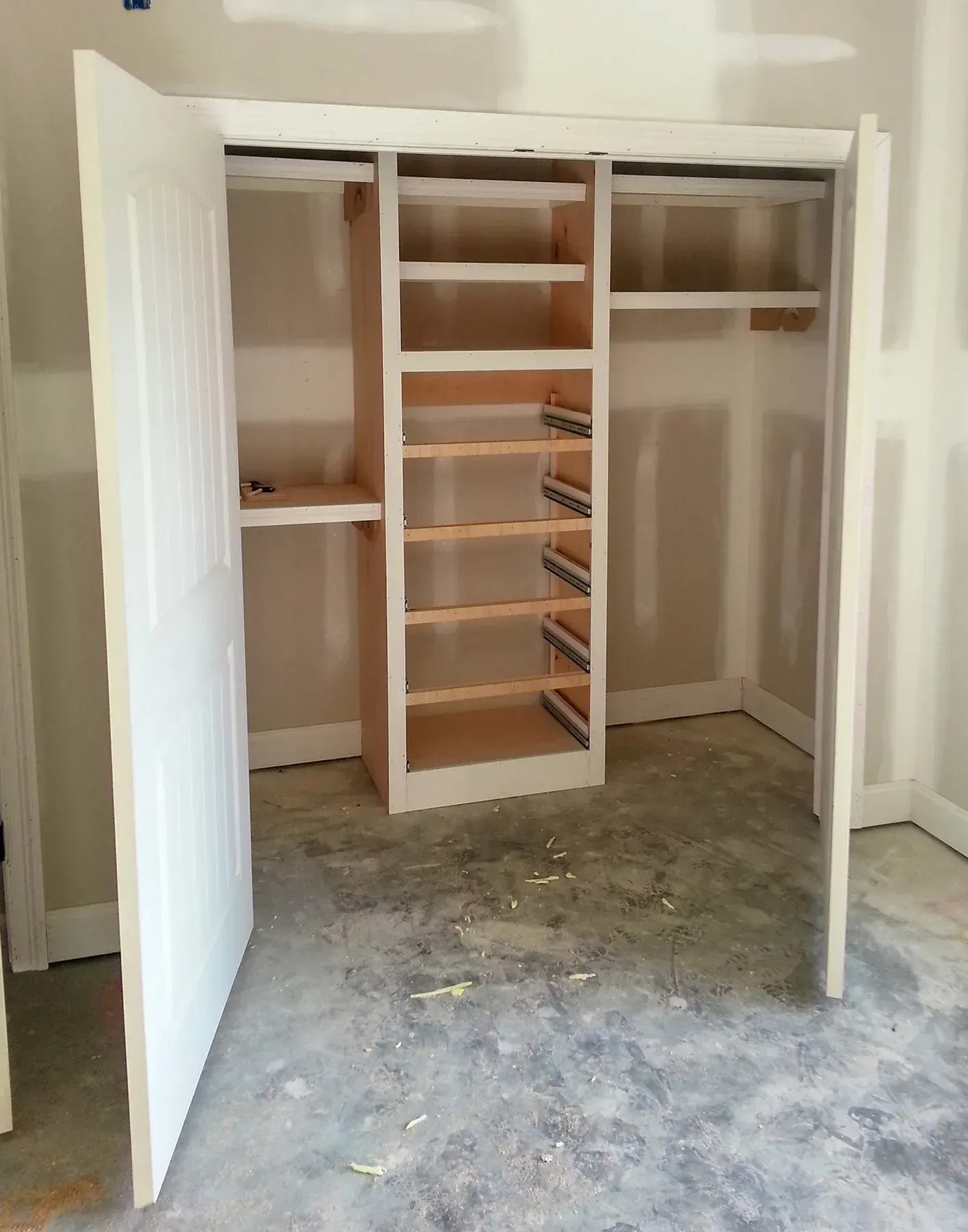 A Closet With Shelves And A Door That Is Open - Raymond, MS - Parker Roofing & Remodeling