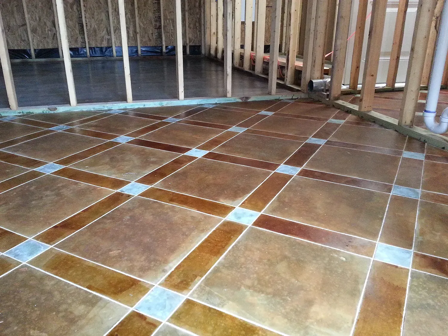 A Tiled Floor With A Wooden Railing In The Background - Raymond, MS - Parker Roofing & Remodeling