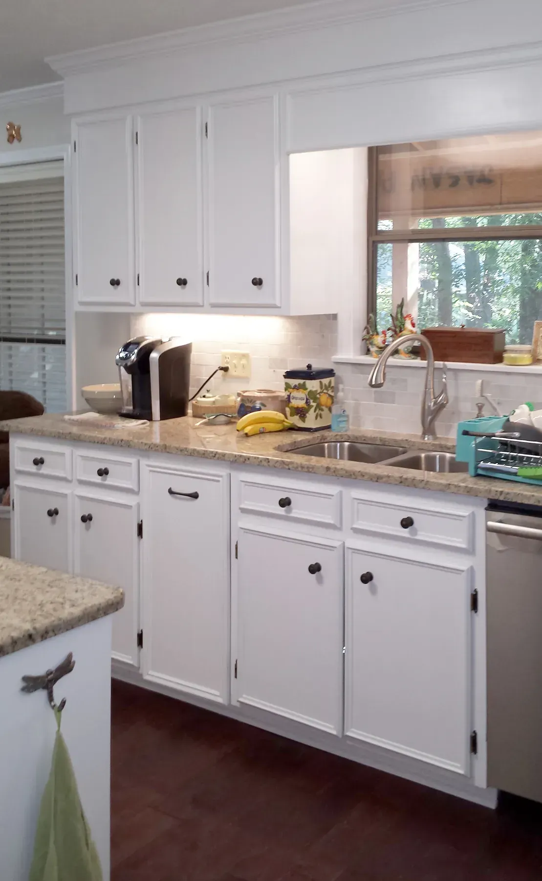 A Kitchen With White Cabinets And Granite Counter Tops - Raymond, MS - Parker Roofing & Remodeling