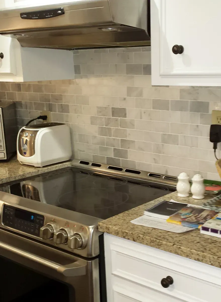 A Kitchen With A Stove Top Oven And A Toaster - Raymond, MS - Parker Roofing & Remodeling