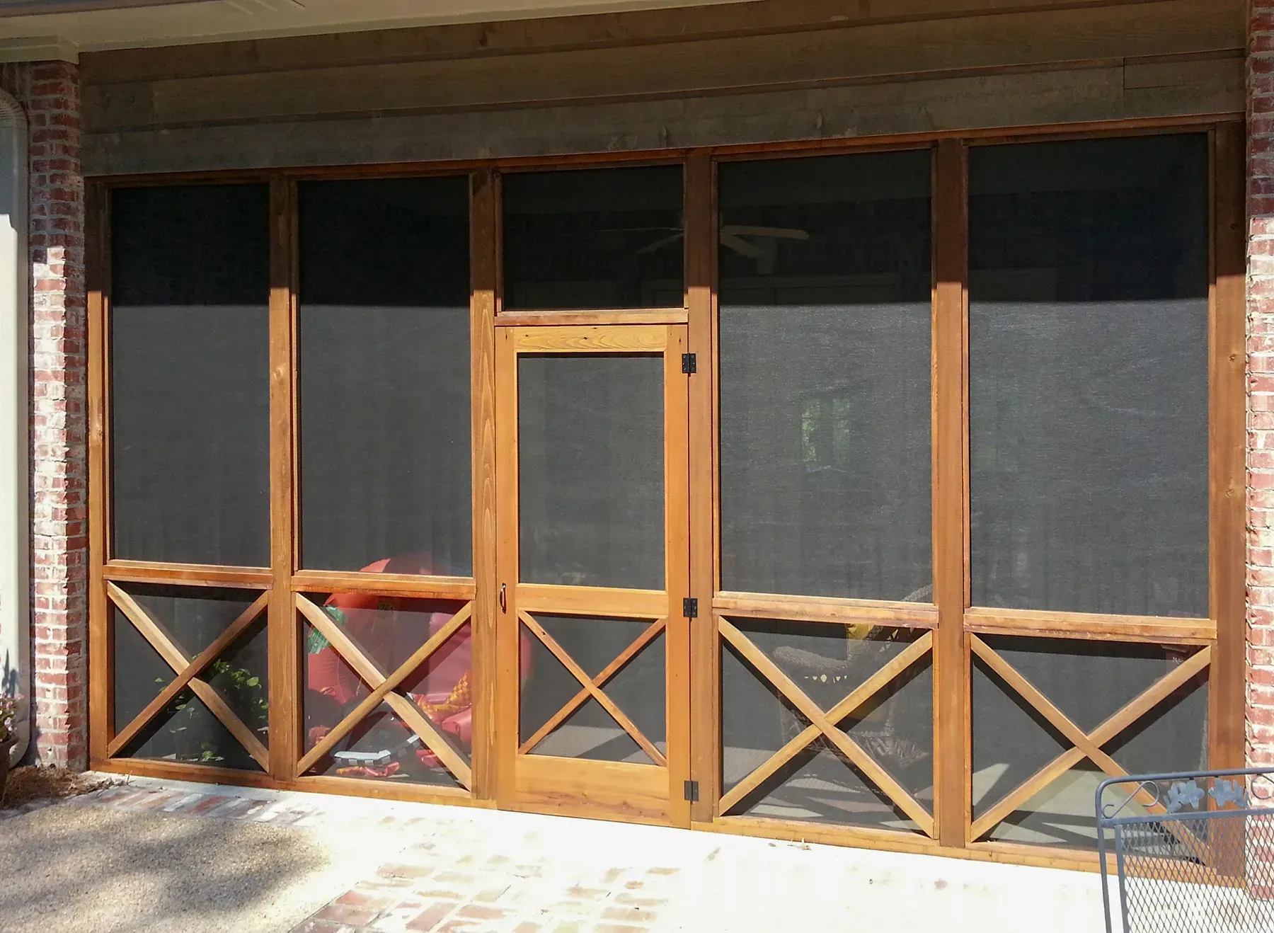 A Screened In Porch With A Wooden Frame - Raymond, MS - Parker Roofing & Remodeling