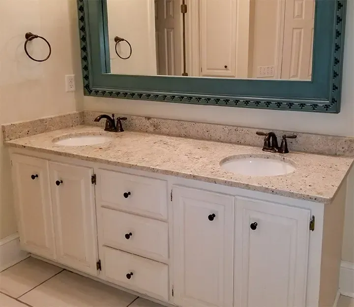 A Bathroom With Two Sinks And A Large Mirror - Raymond, MS - Parker Roofing & Remodeling