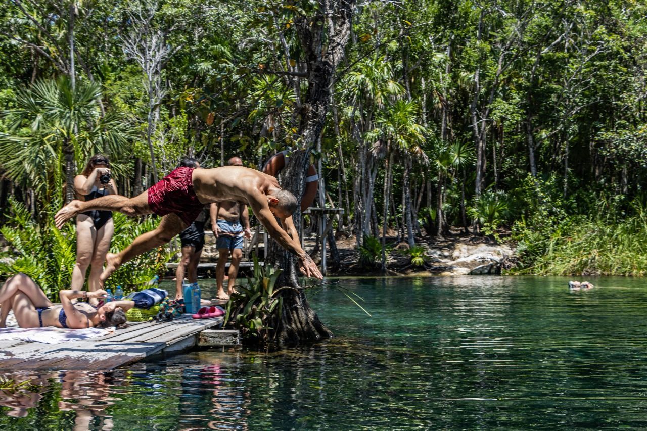 Cool off jumping into cenote crystal-clear waters 