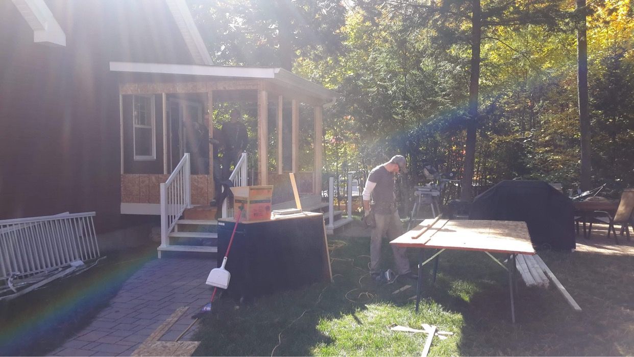 Un homme se tient devant une maison en construction.