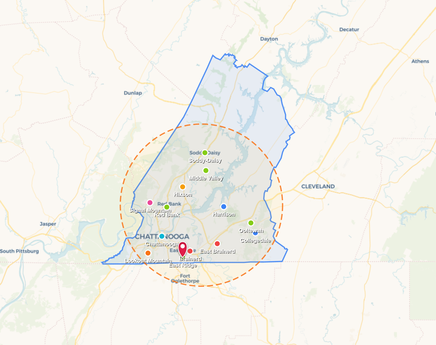 Map with green and blue outlined regions, clustered markers, and a dashed orange circle highlighting a central area