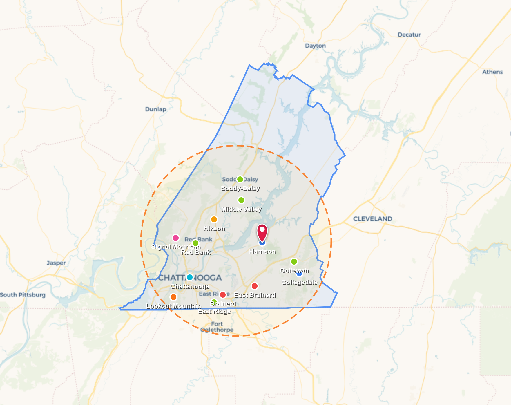 Map with a green and blue boundary, orange dashed circle, and multiple location markers near a city cluster