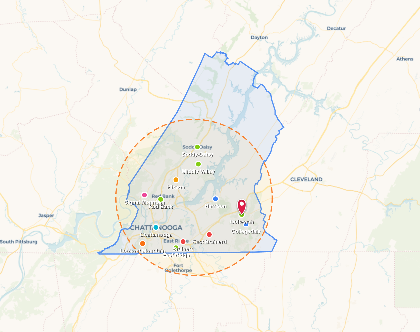 Map with blue and green boundary lines, clustered markers, and a dashed orange search radius centered near a red pin.