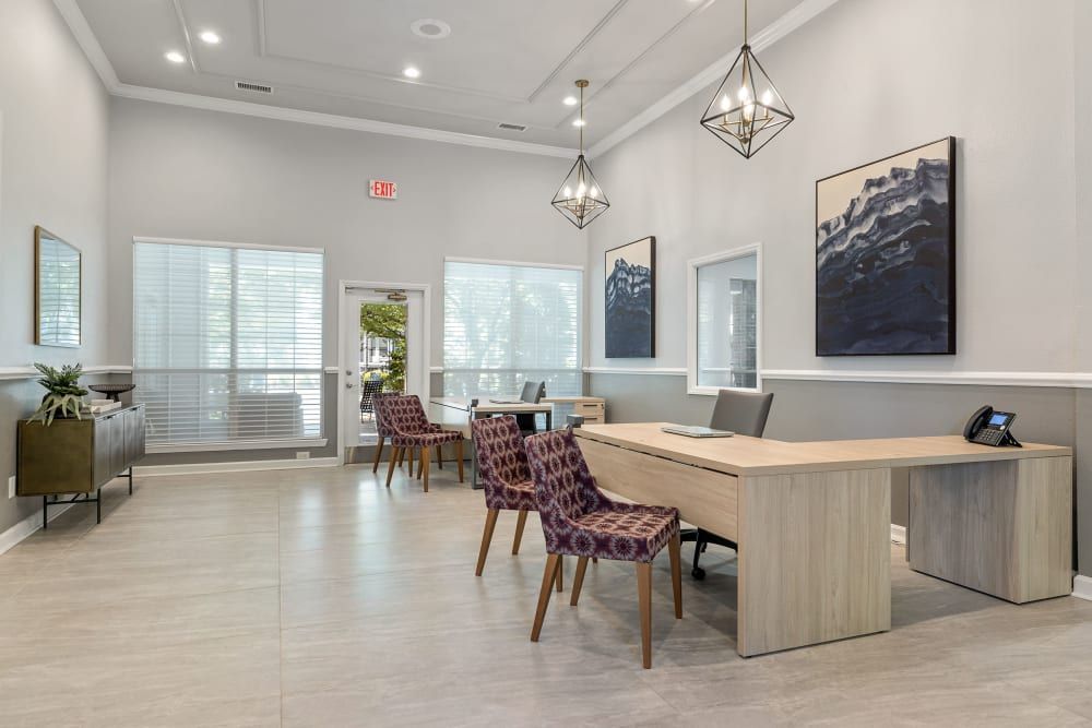 a large room with a desk and chairs in it at Marquis Carmel Valley in Charlotte, NC.