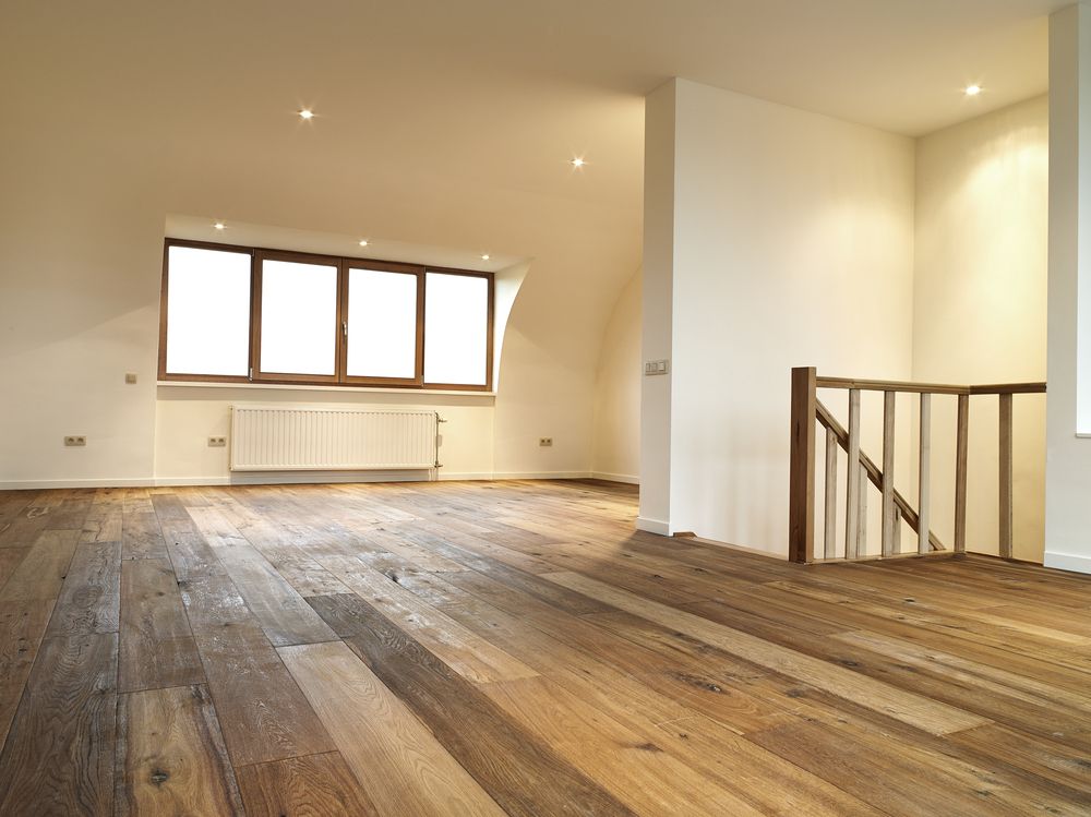 Empty Room with Wooden Floors White Walls and A Staircase Railing — Toowoomba Polished Floors in Murphy's Creek, QLD