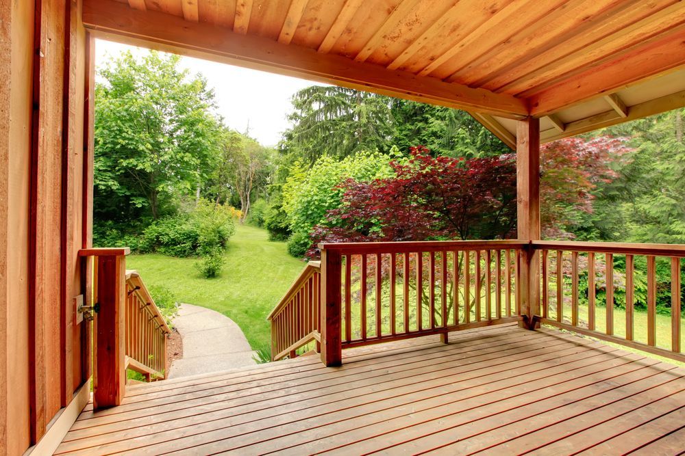 Wooden Porch Overlooking a Green Yard with Steps Leading to A Pathway — Toowoomba Polished Floors in Oakey, QLD