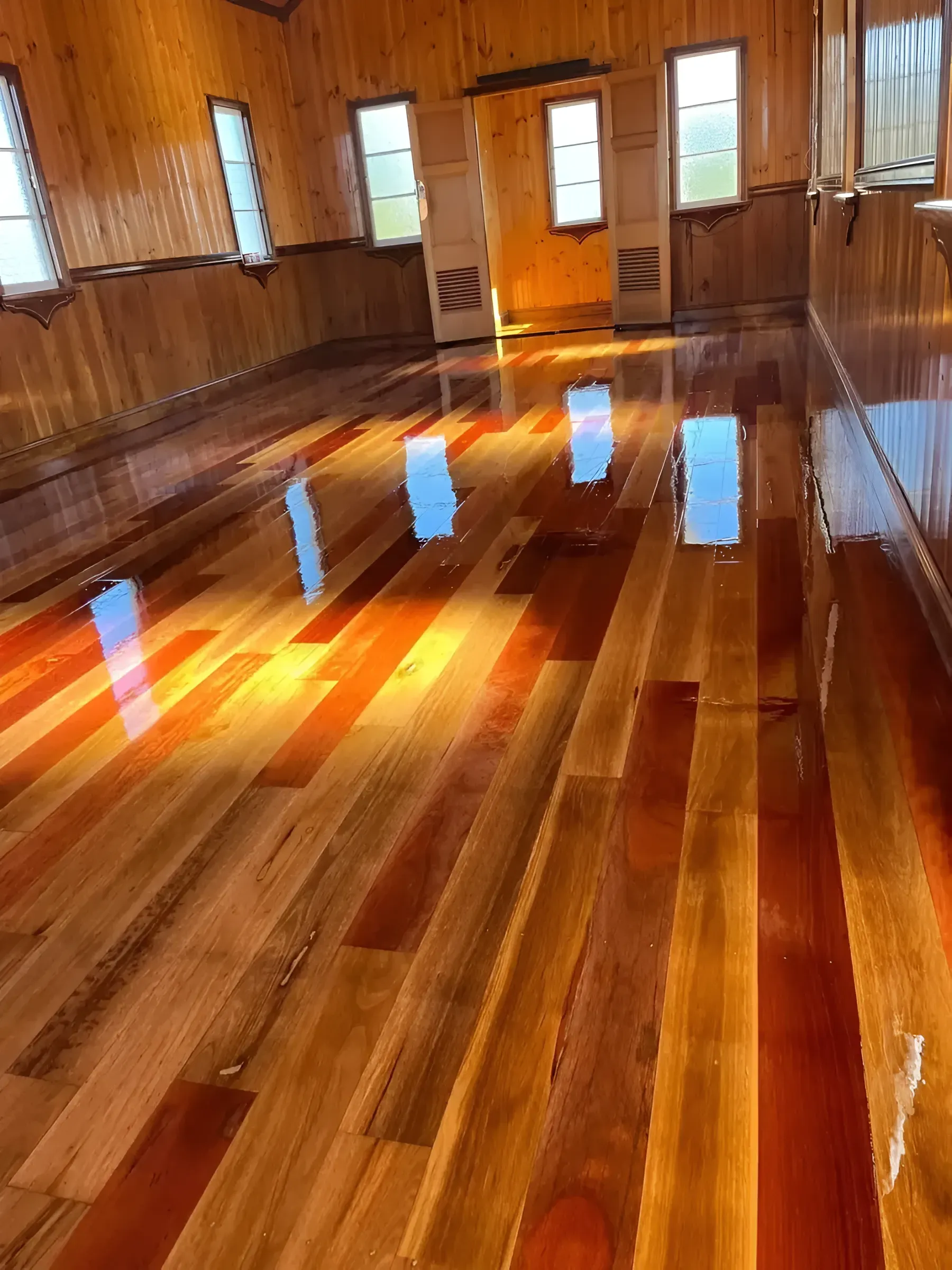 Shiny Wooden Floor and Walls Inside a Brightly Lit Room — Toowoomba Polished Floors in Warwick, QLD