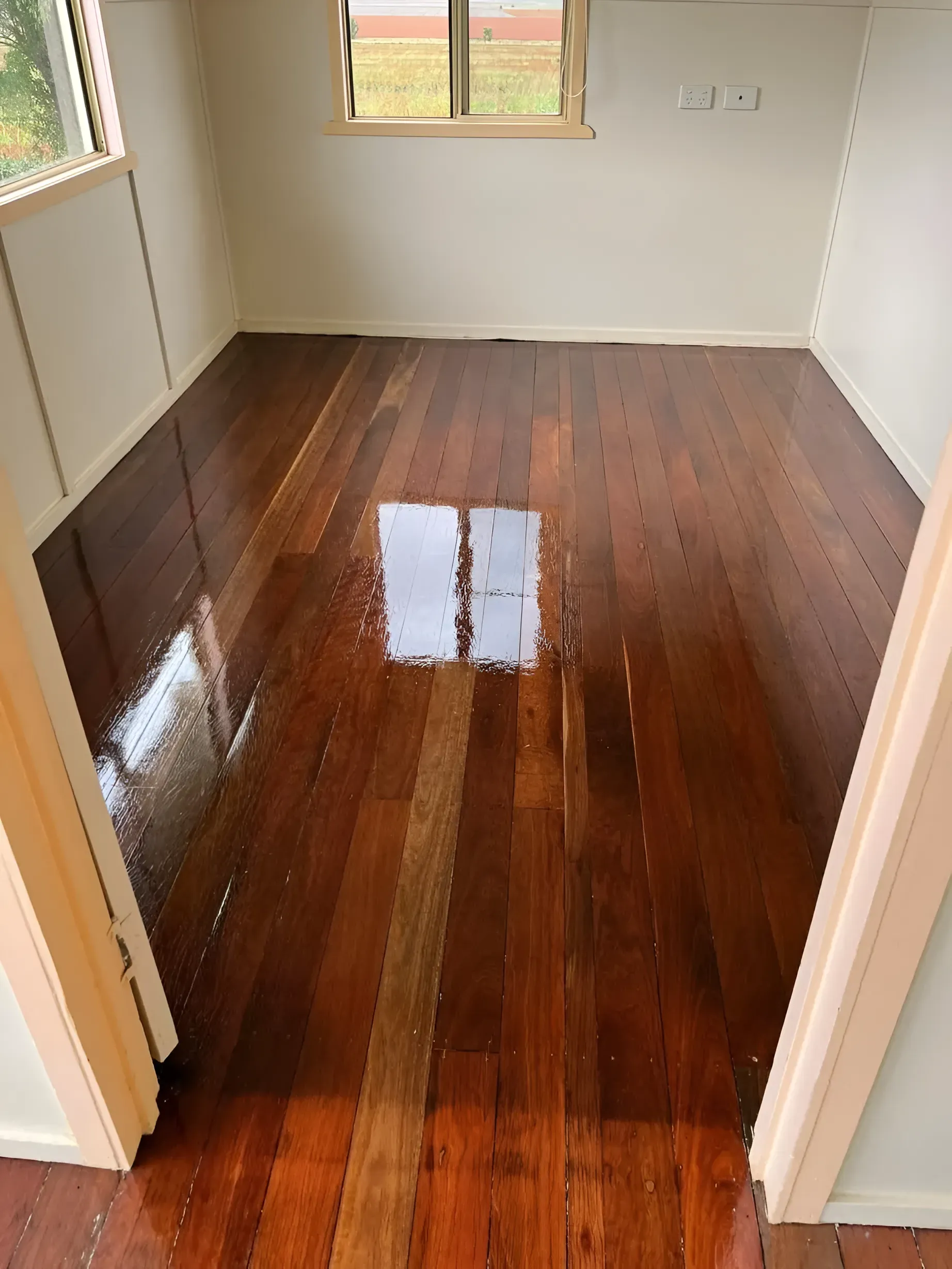 A Room with Polished Dark Wood Floors Reflecting the Light — Toowoomba Polished Floors in Warwick, QLD