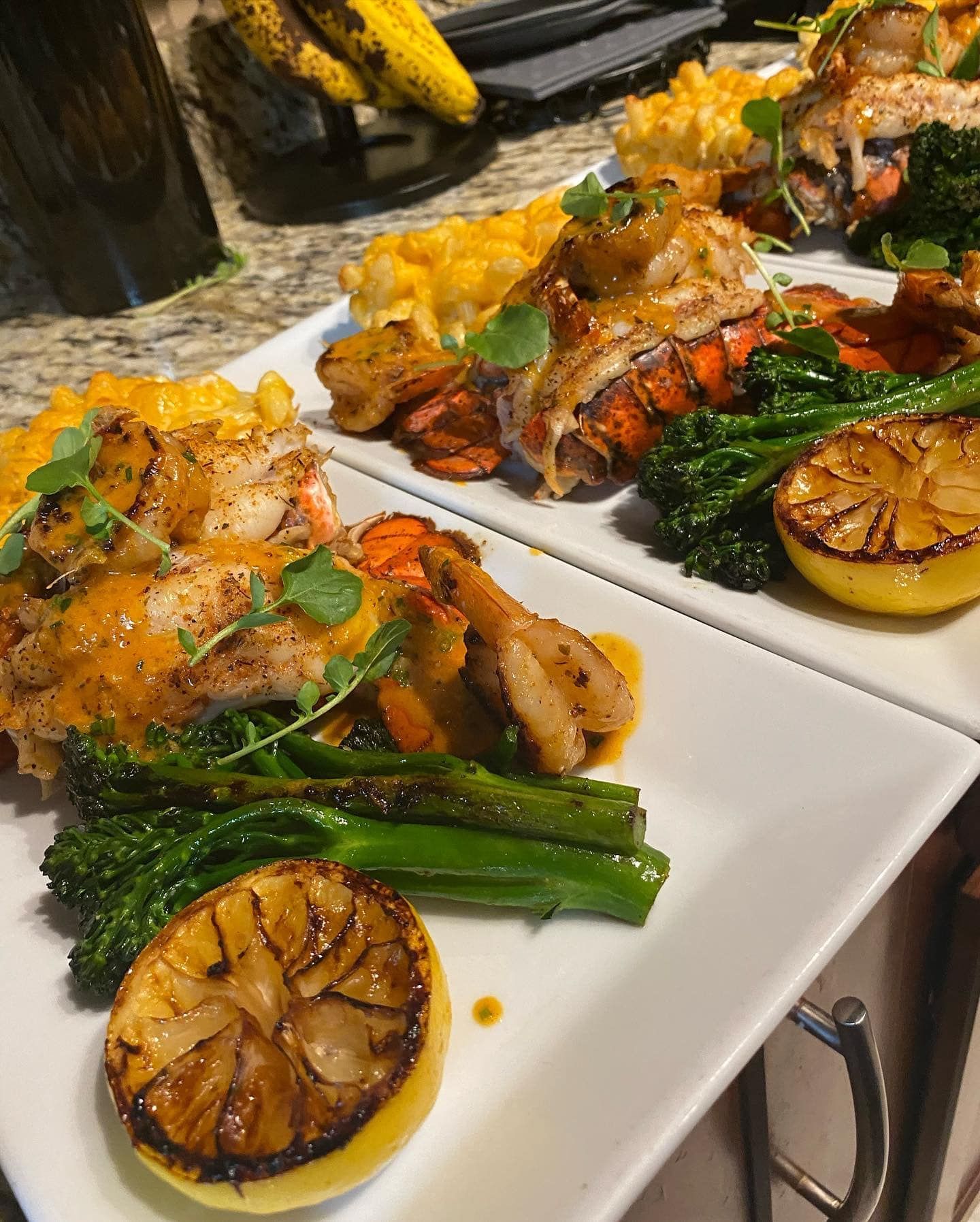 Two plates of food are sitting on a counter.