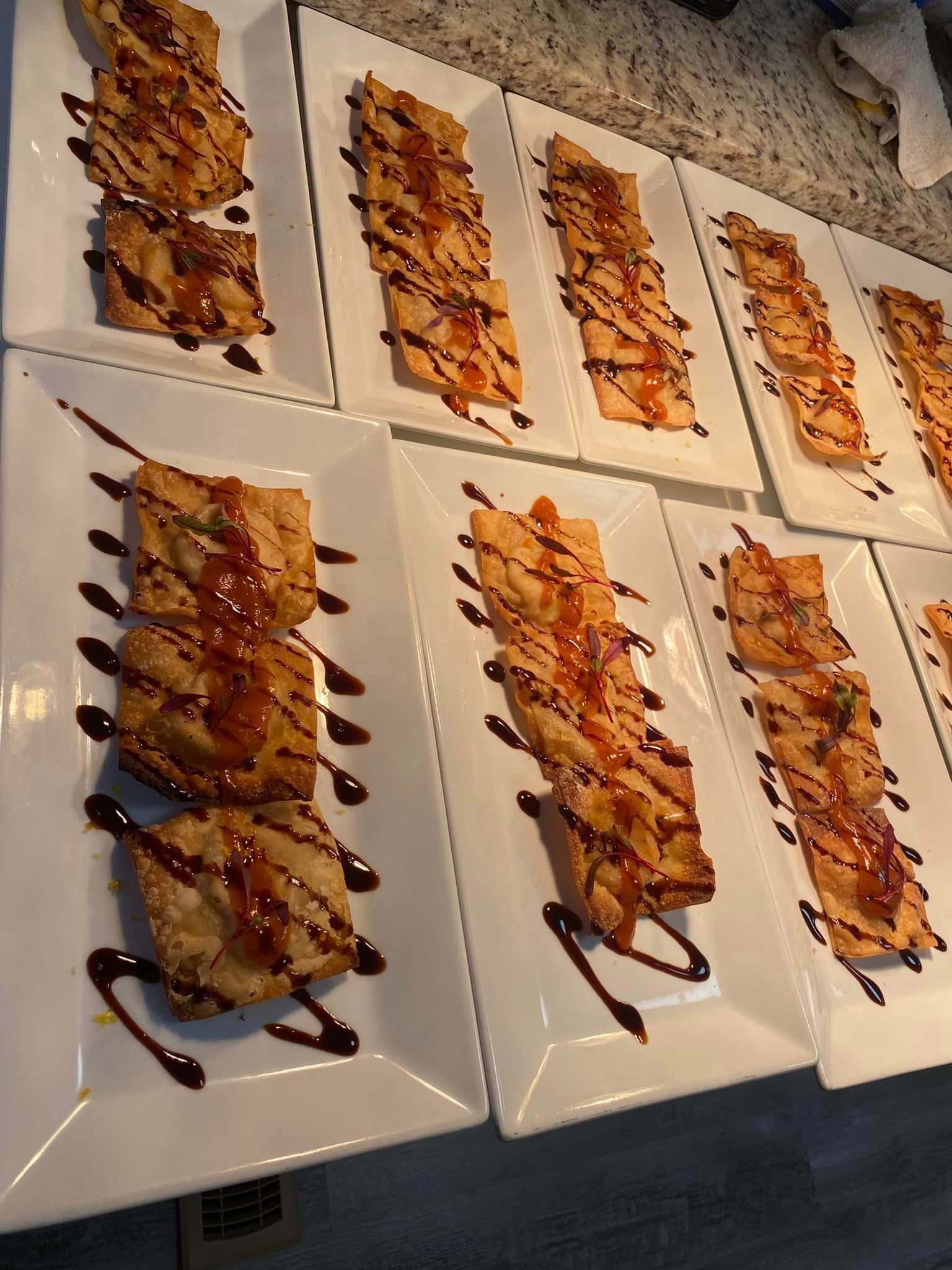 A bunch of plates of food with sauce on them
