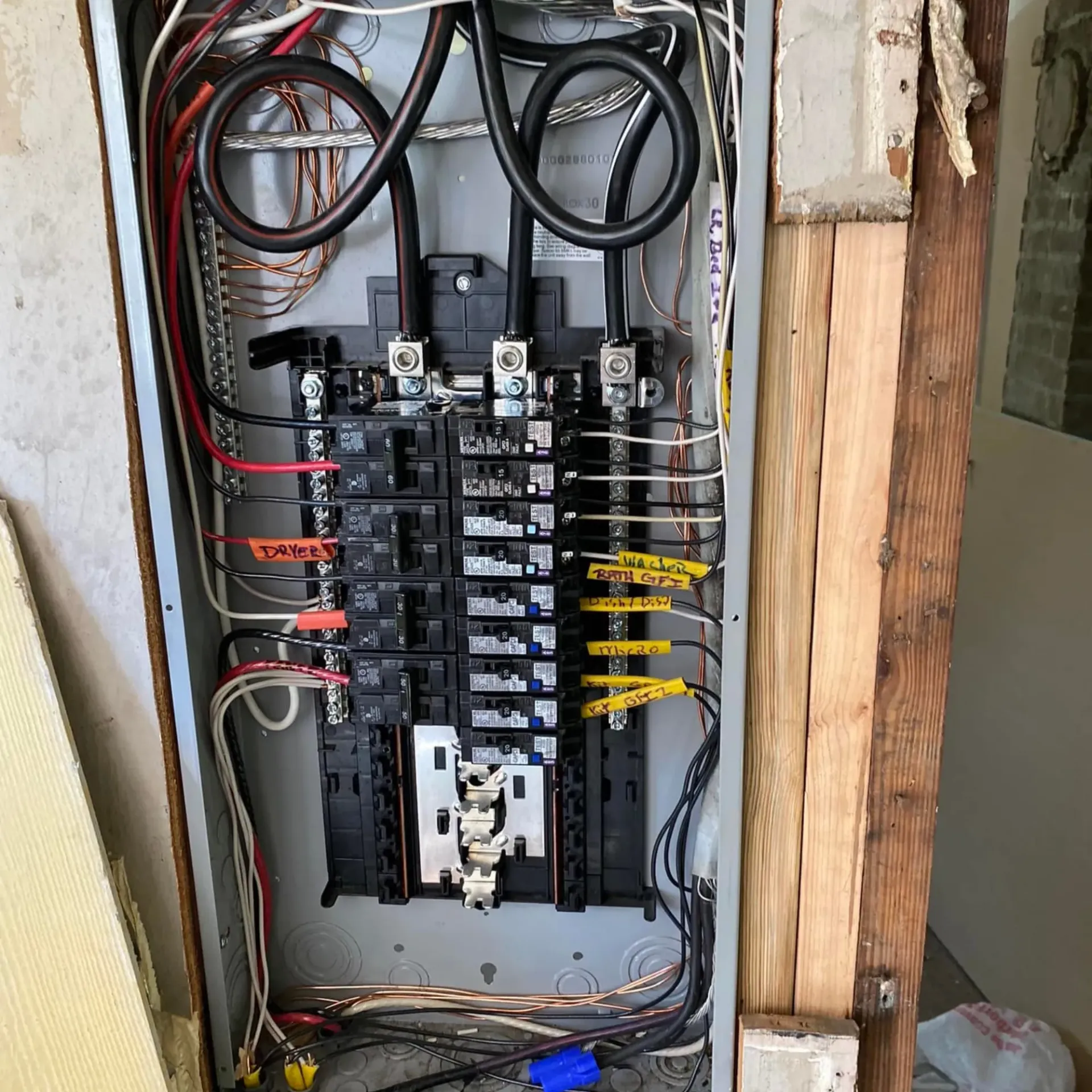 Service of Knights LLC - A electrical panel with a lot of wires and a pair of scissors.