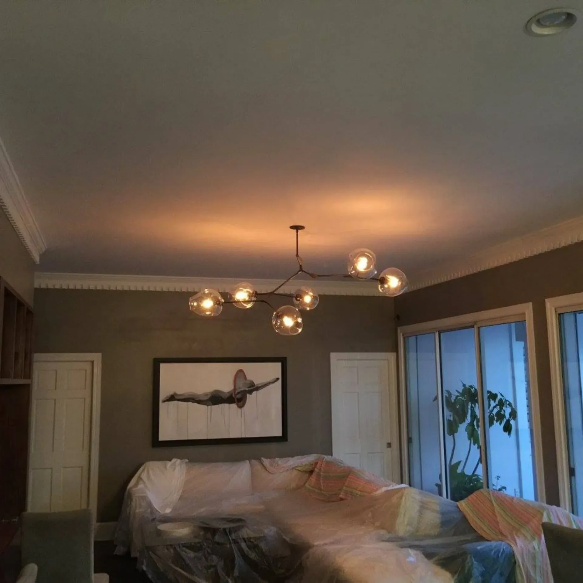 Service of Knights LLC - A living room with a couch and a picture on the wall