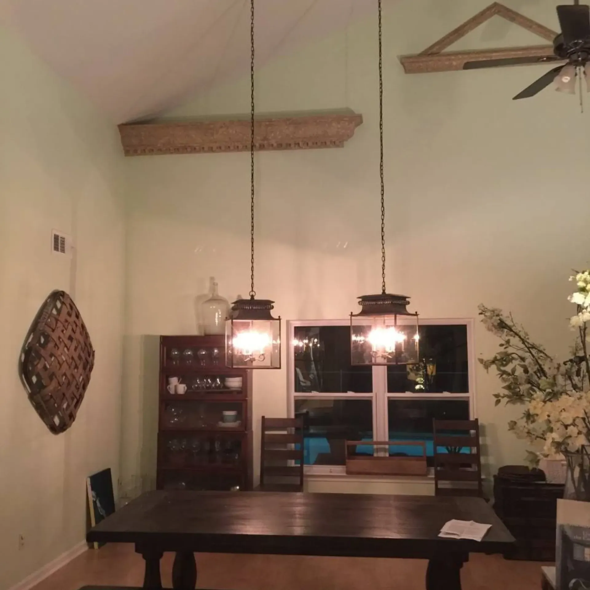 Service of Knights LLC - A dining room with a table and chairs and a ceiling fan