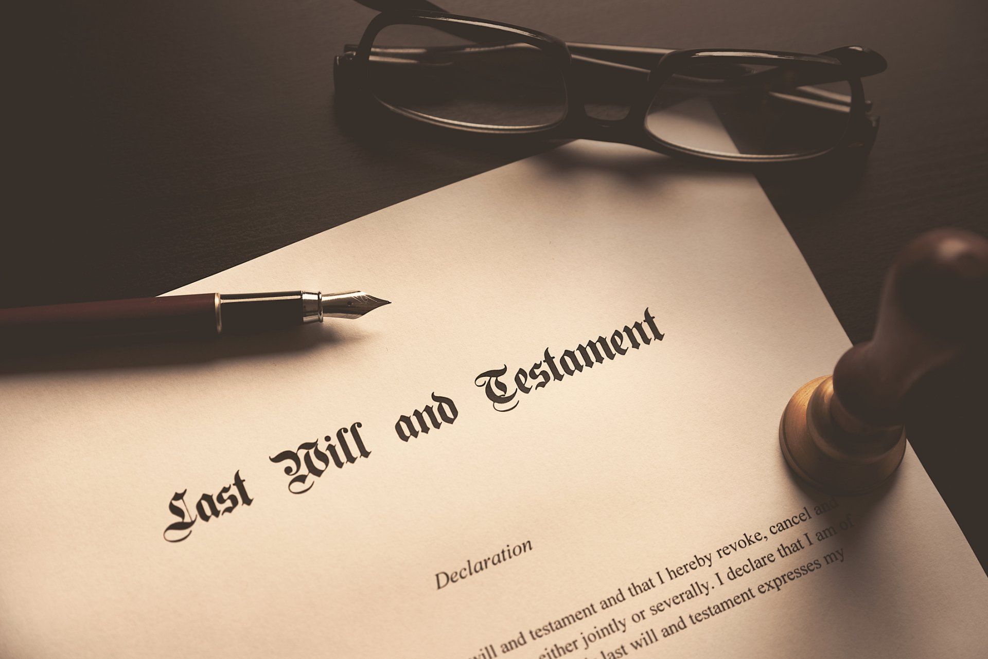 A last will and testament with a pen and glasses on it
