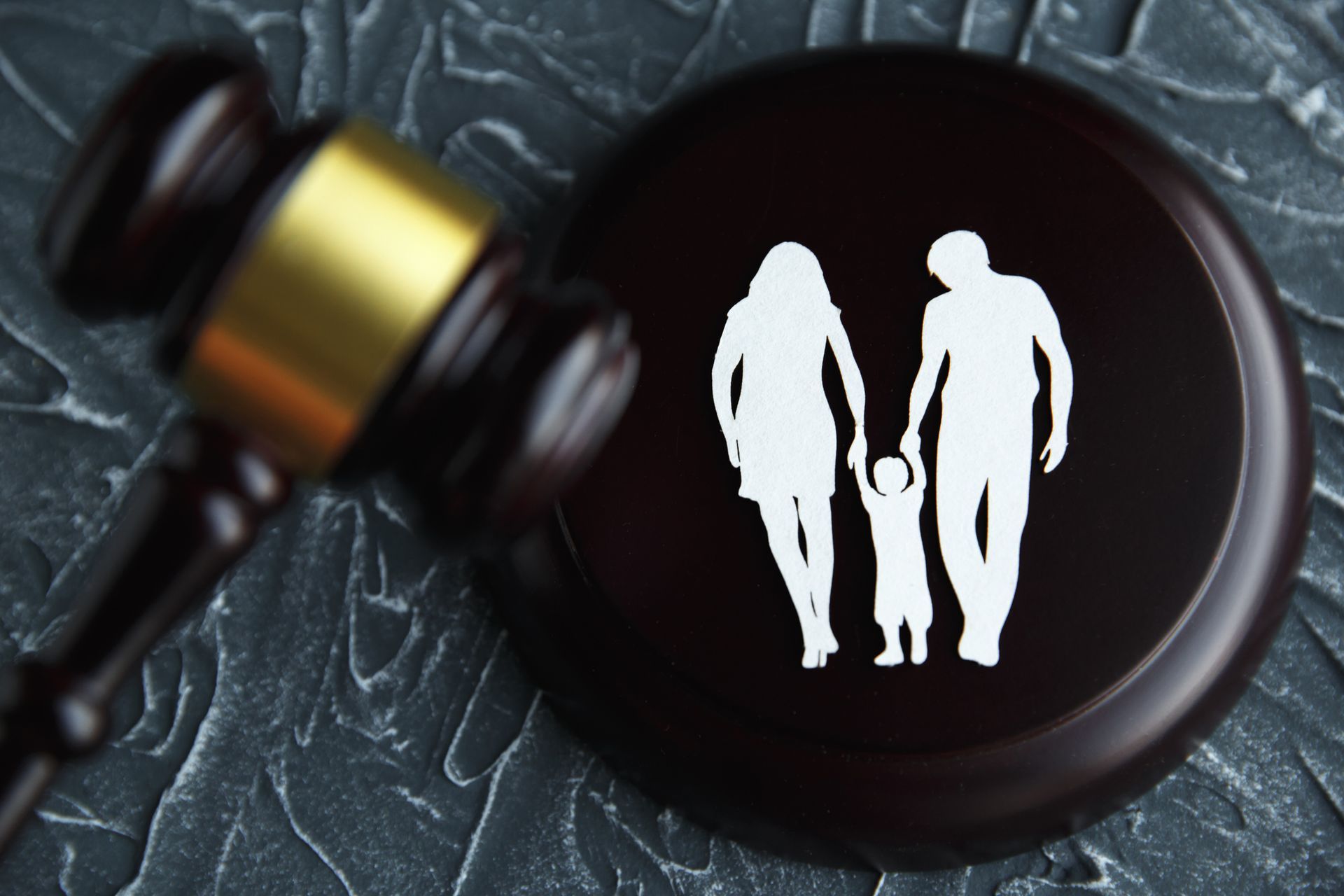 A wooden gavel with a picture of a family on it