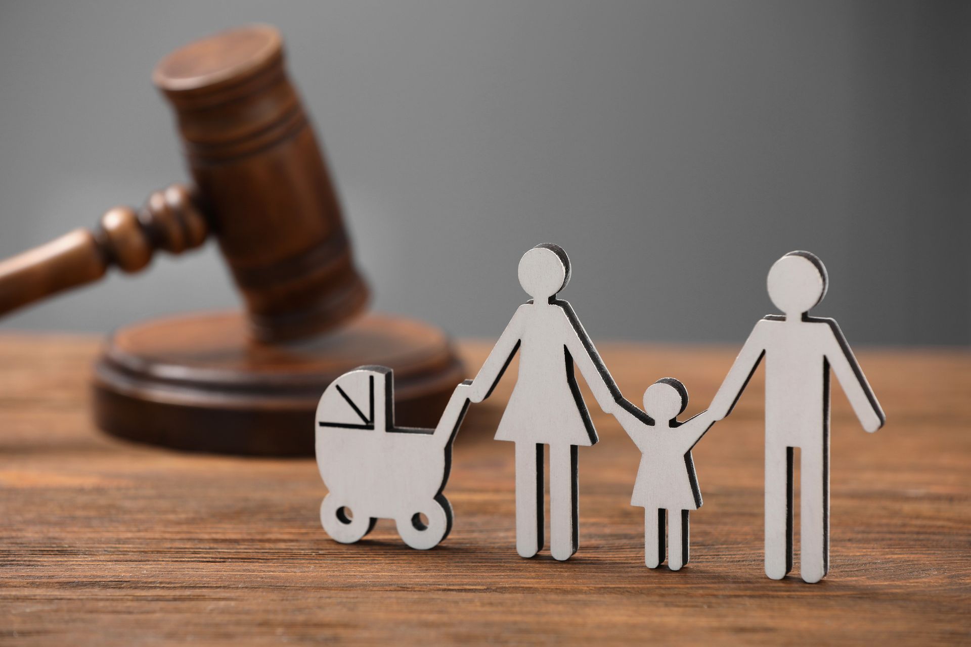 A wooden family with a judge 's gavel in the background.