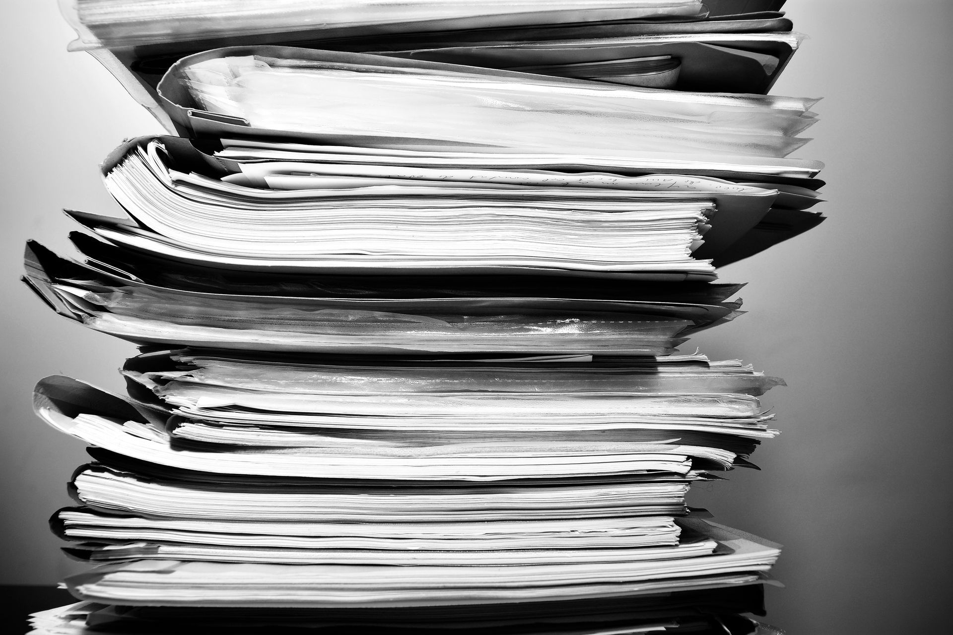 A black and white photo of a stack of papers.