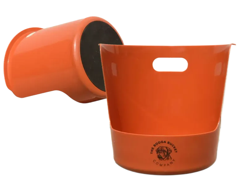 Two orange nesting flower pots, one tipped on its side and one upright with a handle slot