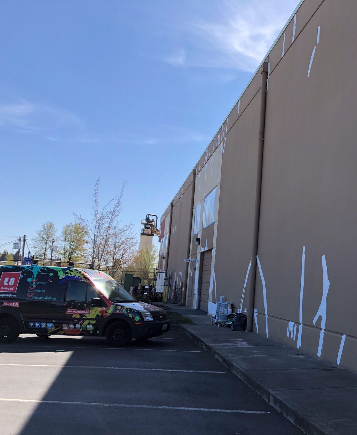A van is parked in front of a large building