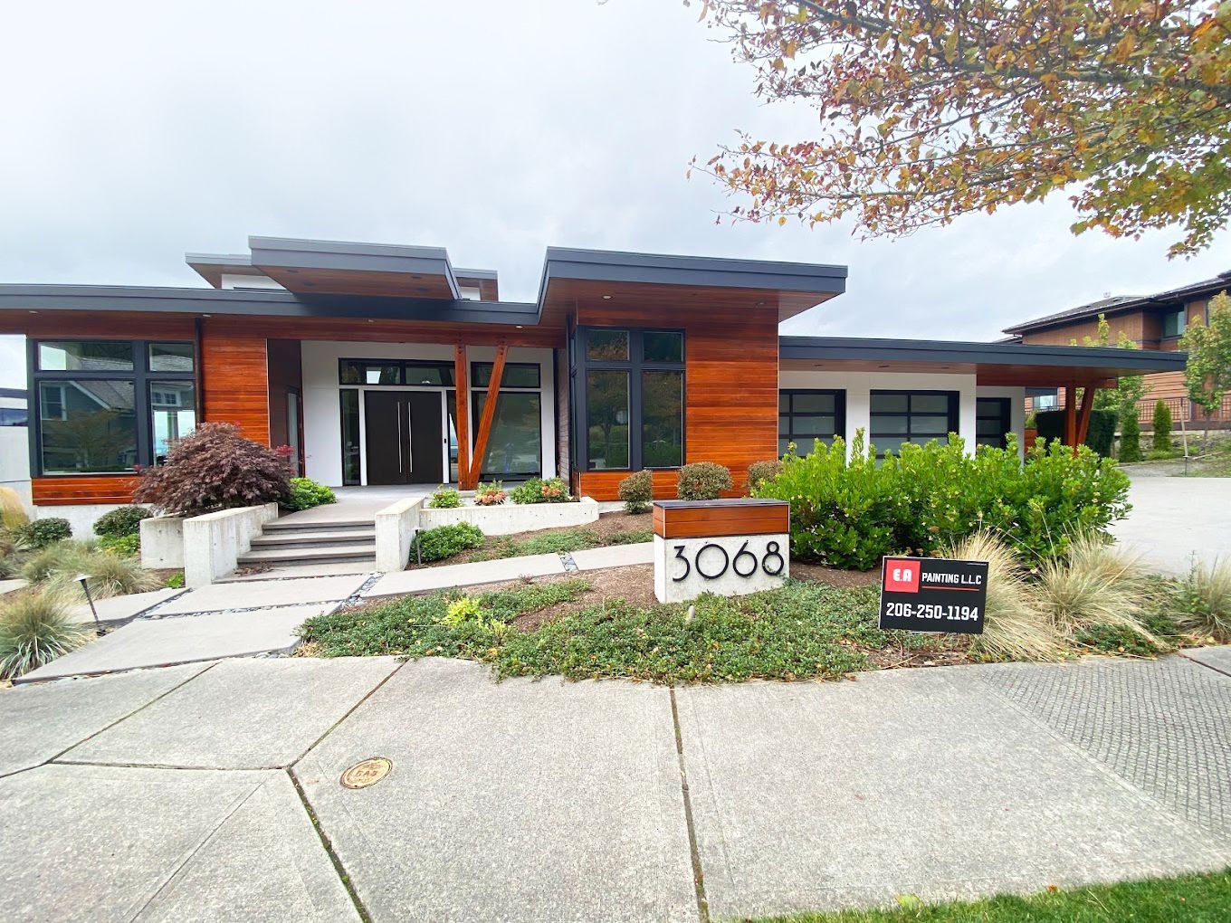 A large house with a lot of windows is for sale.