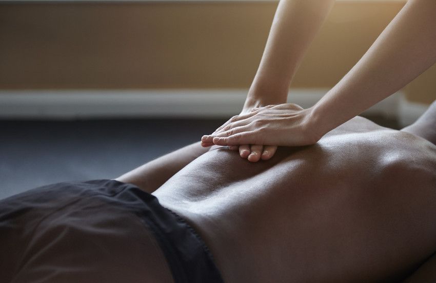 Osteopath giving hands on  treatment for back pain