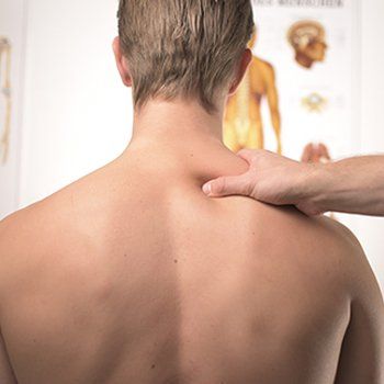 Hand on back and shoulder