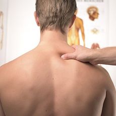 Hand on back and shoulder