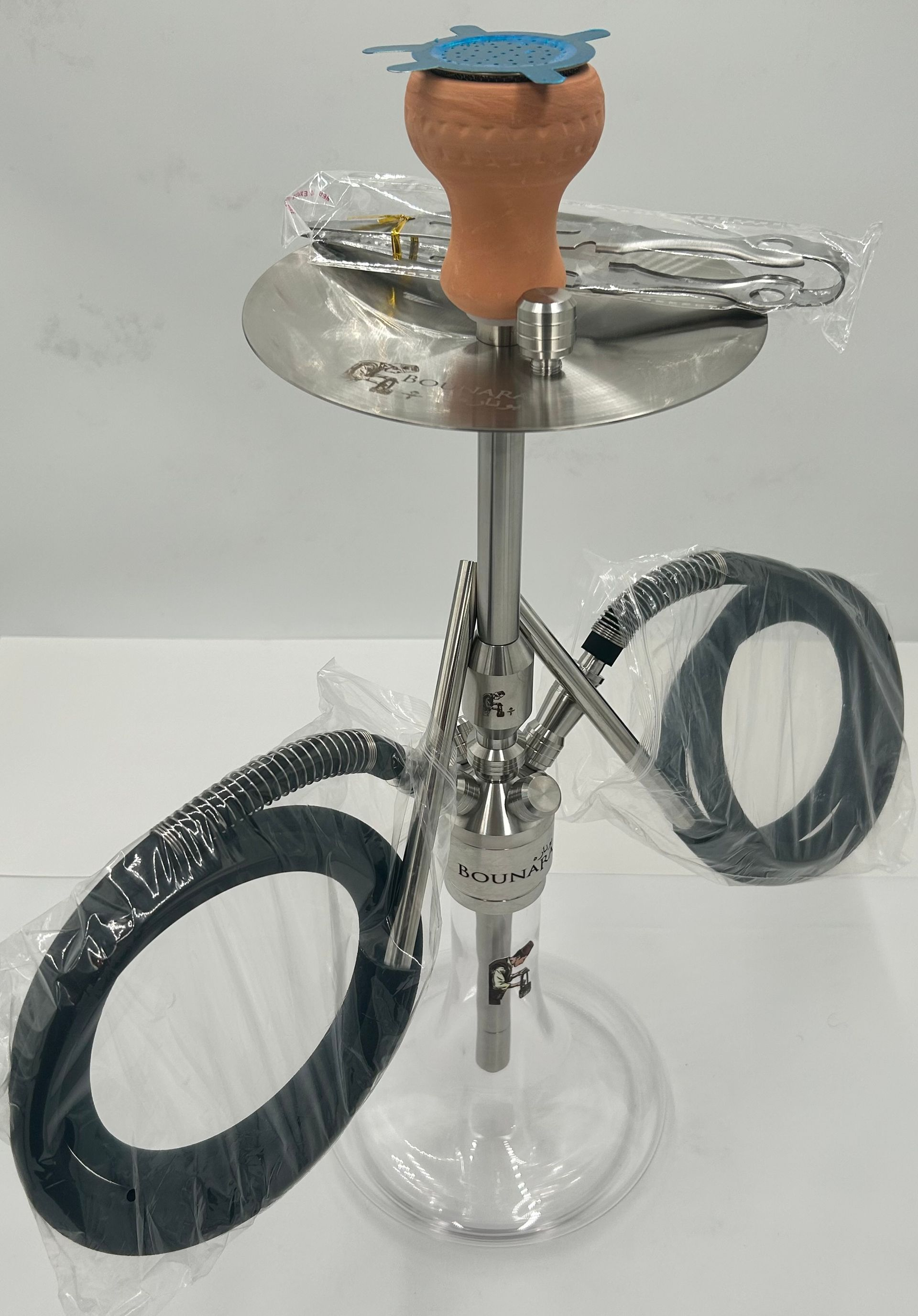 Hookah with glass base and silver stem, wrapped hoses, and a blue clay bowl on top