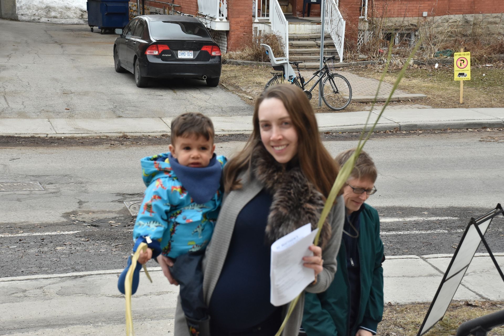 mother carrying child on Palm Sunday