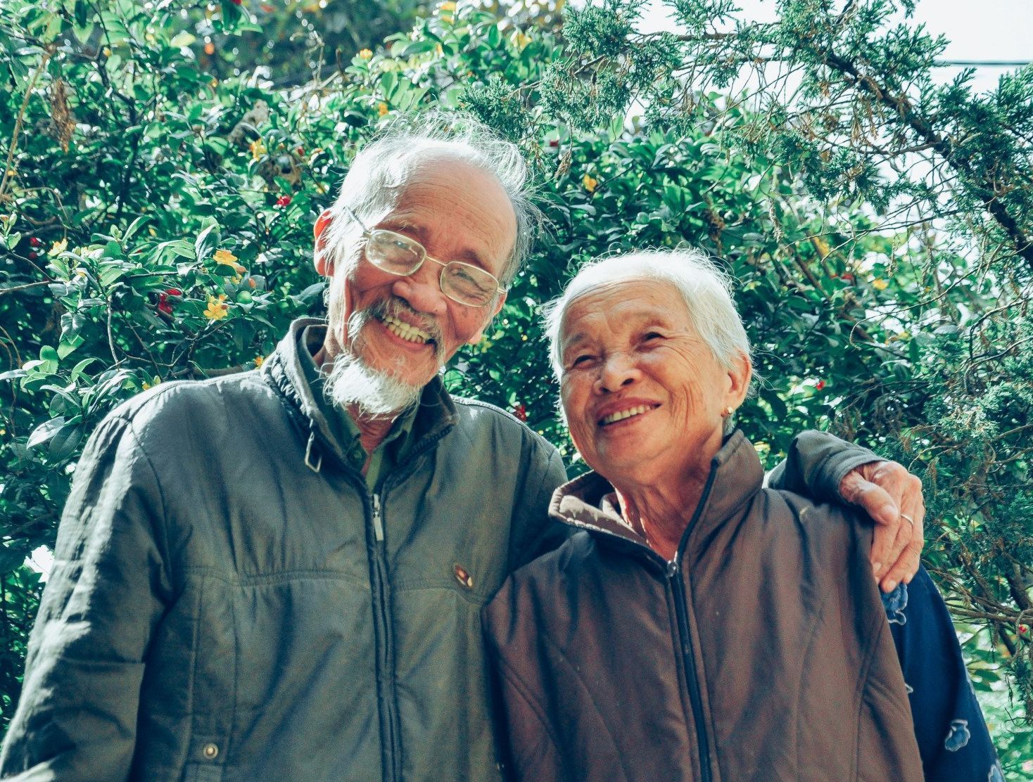 happy senior couple smiling outside