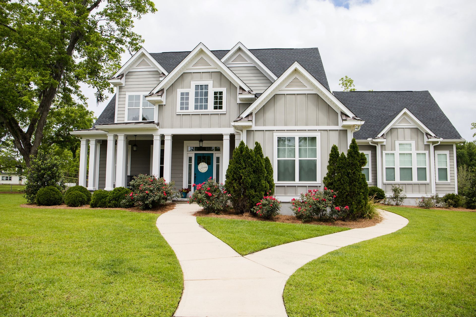 A large house with a walkway leading to it.