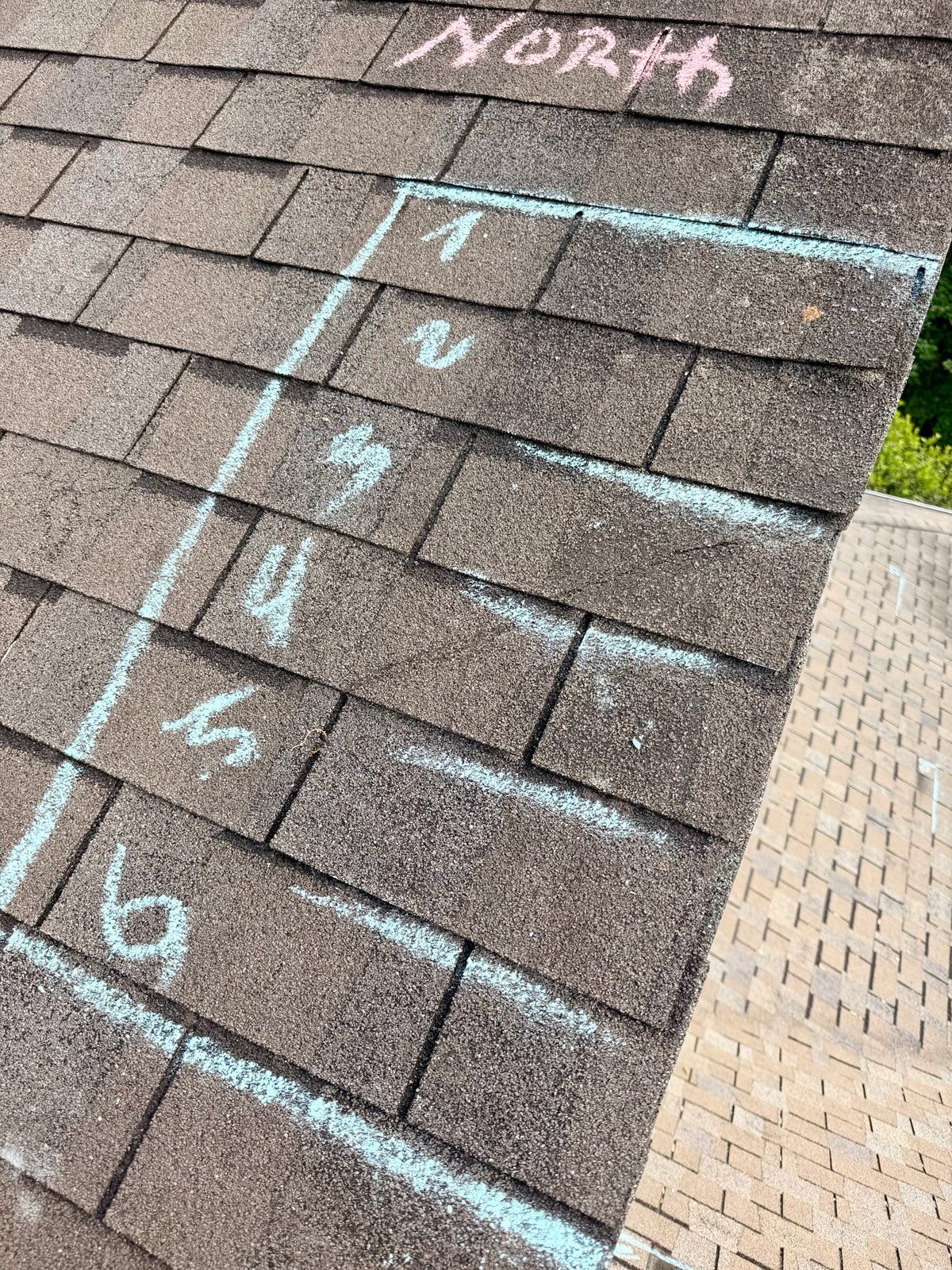 Rooftop marked with chalk lines and numbers, labeled “North” in pink.