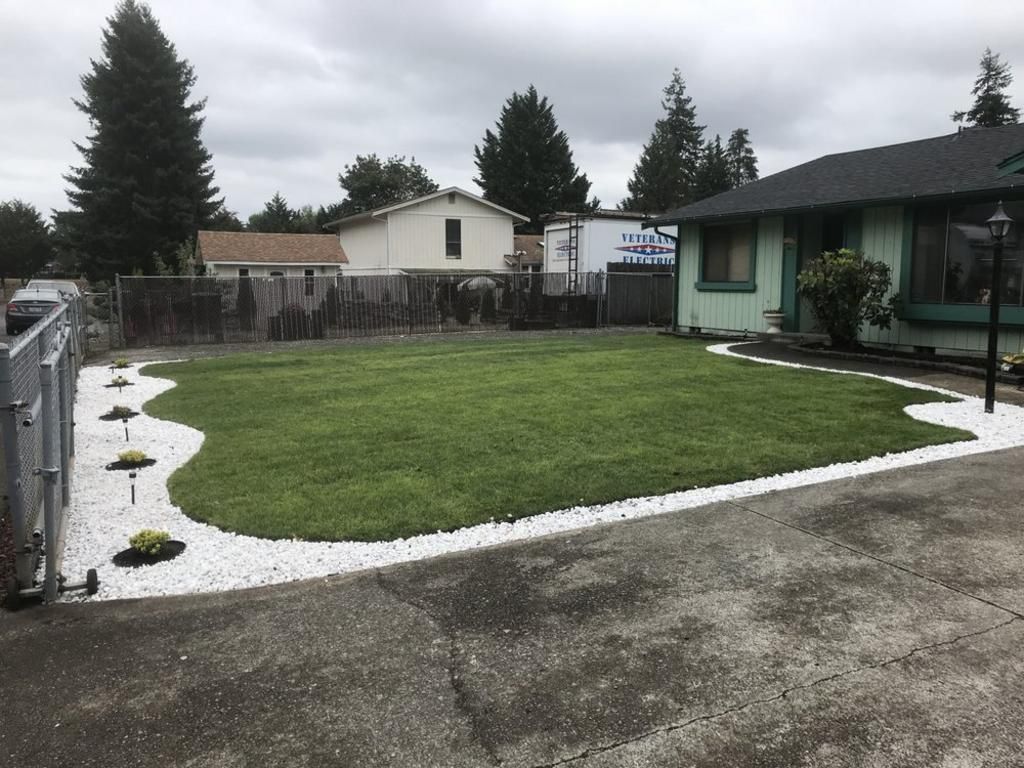 A house with a large lawn in front of it
