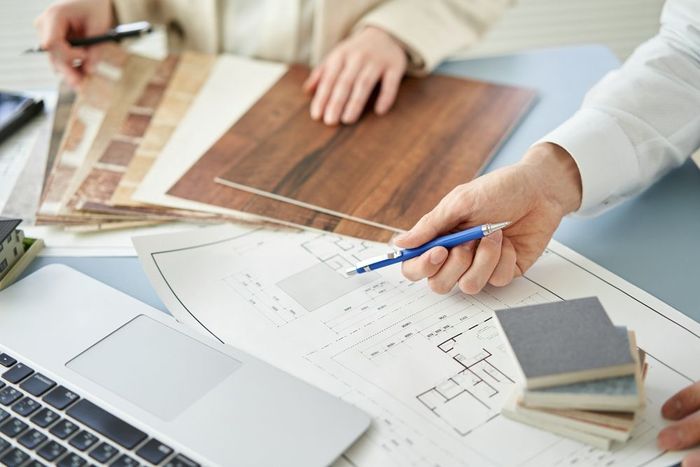 A person is holding a pen over a piece of paper.
