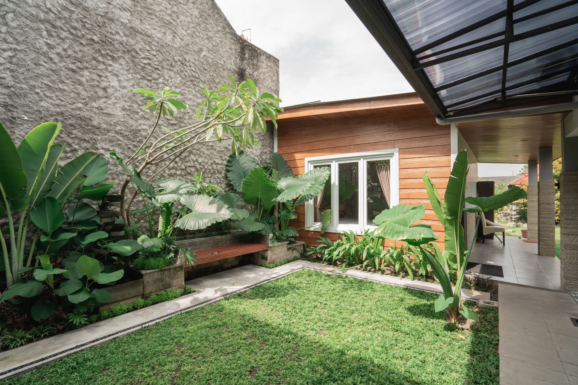A house with a large lawn in front of it.