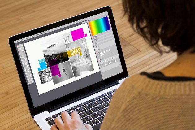 A person using a laptop with design software displayed on the screen featuring a collage of black-and-white photos.