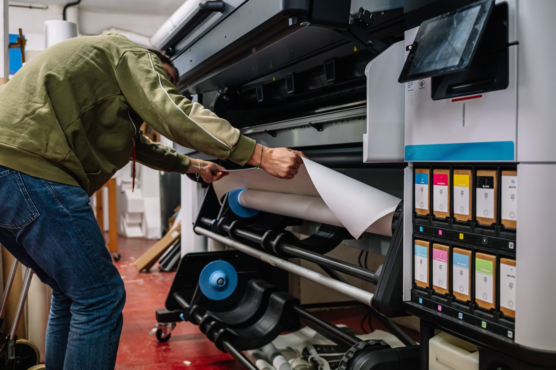 Man printing banner in printing office.