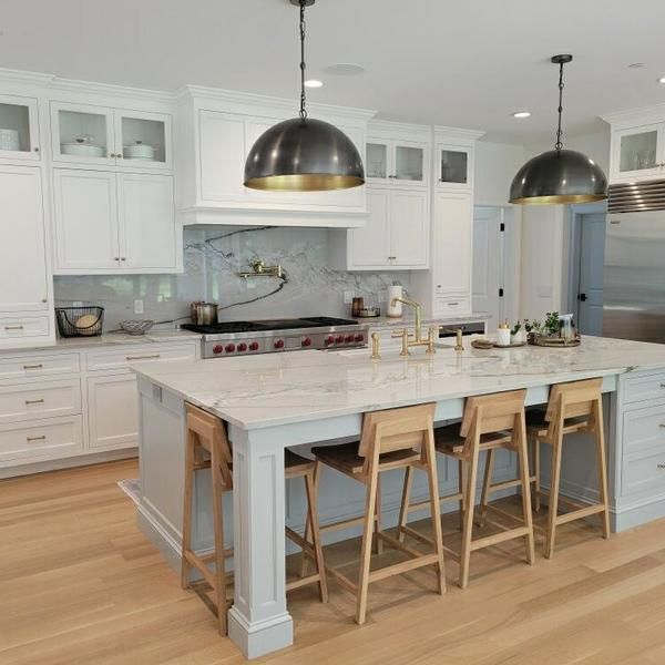 A kitchen with a large island and stools
