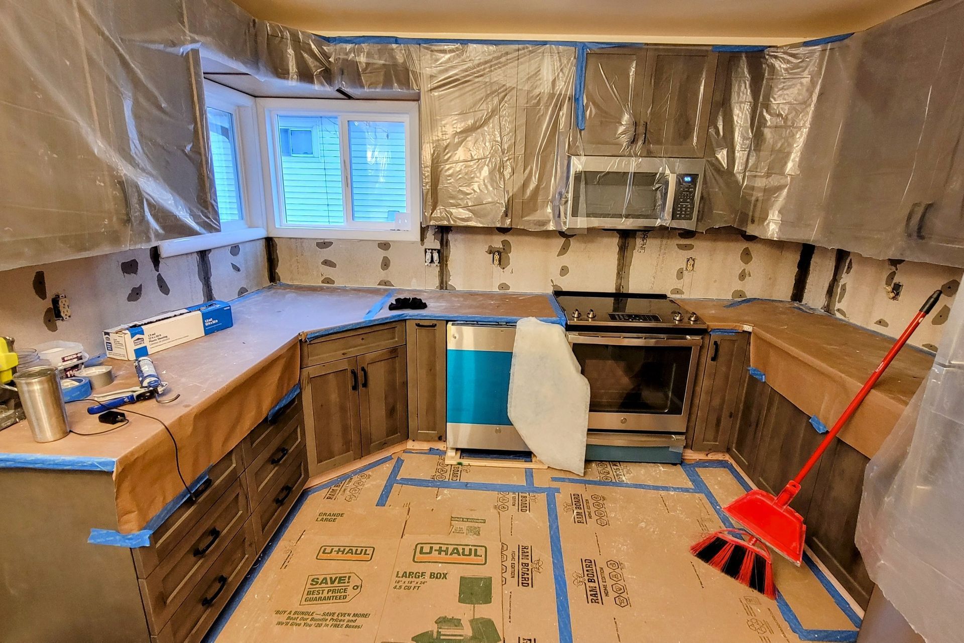 A kitchen under construction with a broom on the floor.