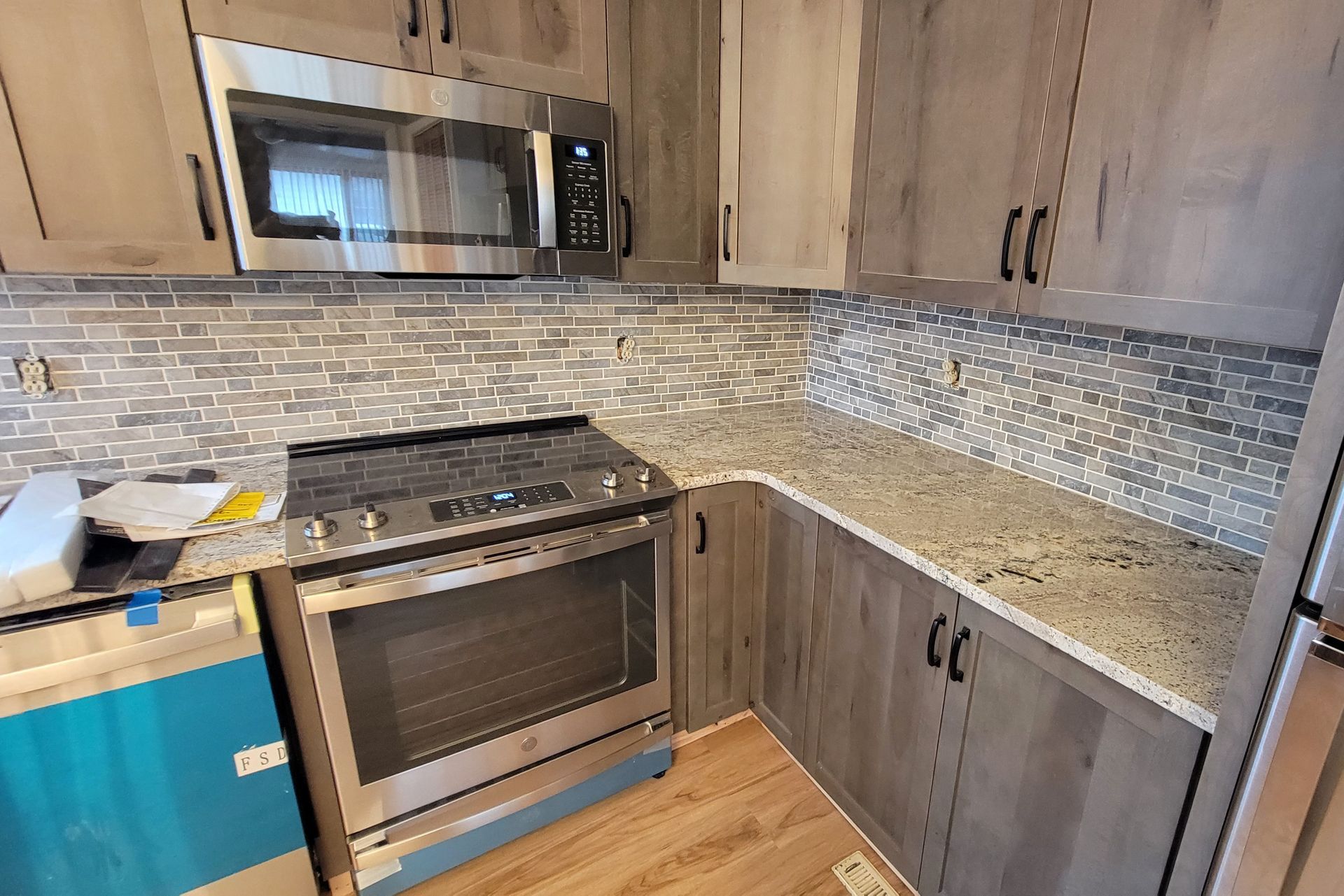 A kitchen with stainless steel appliances and granite counter tops.