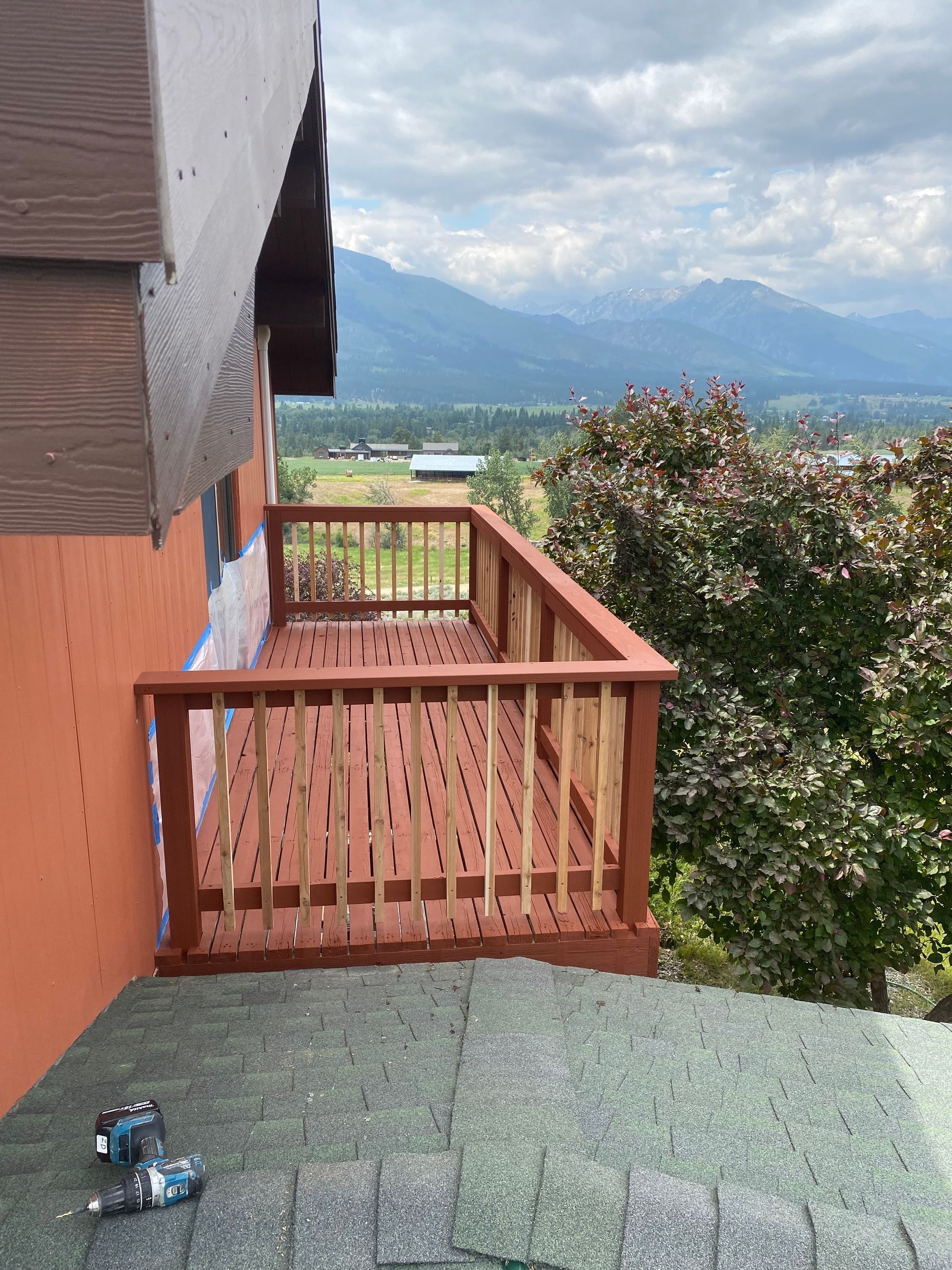 A wooden deck is being built on the side of a house.